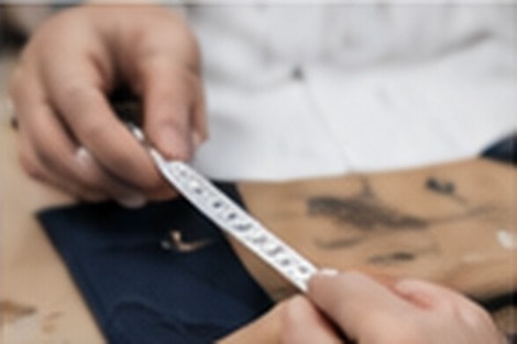 Close-up of a measuring tape being used to check garment sizing